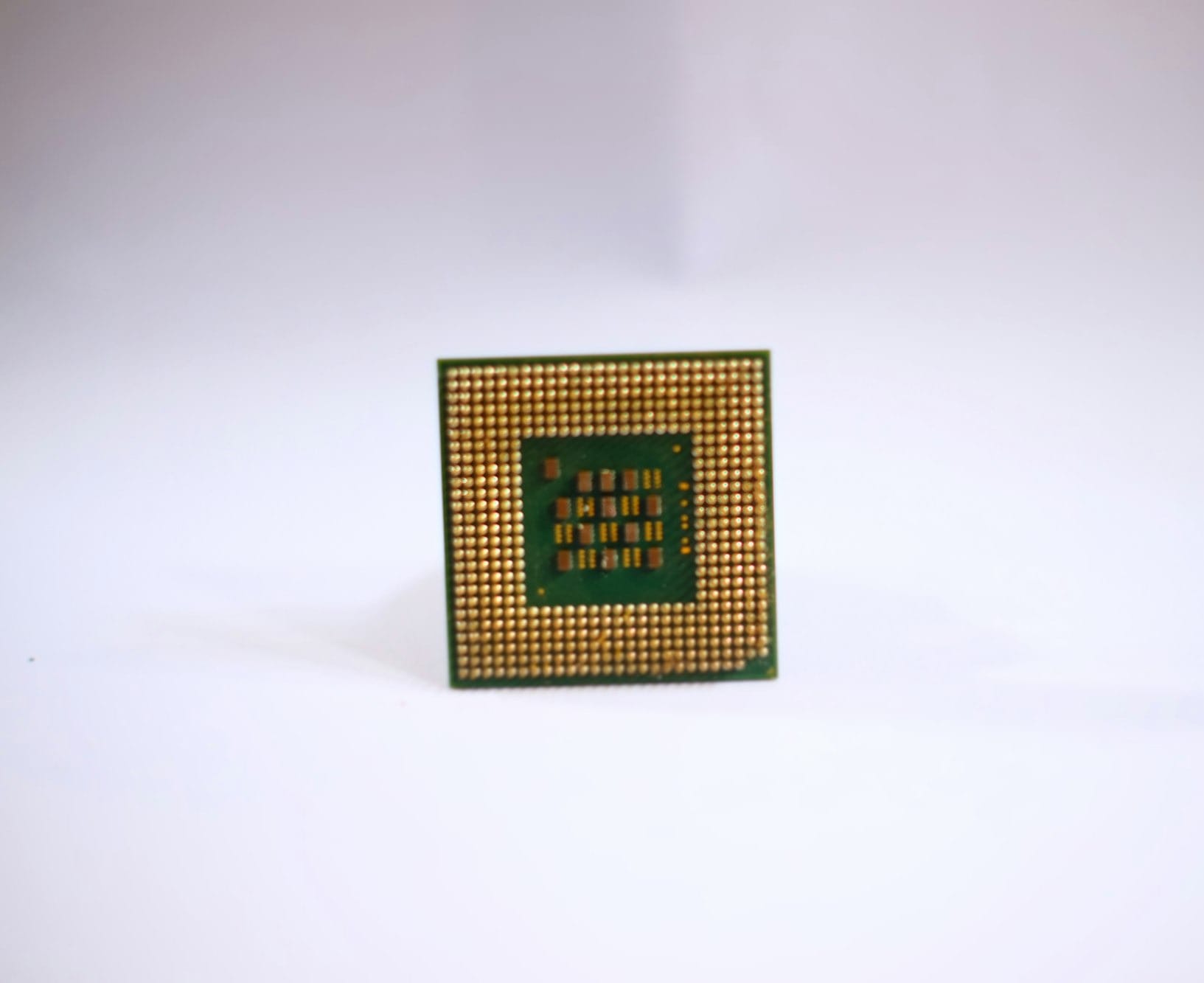 a small square object with a green and yellow design on it